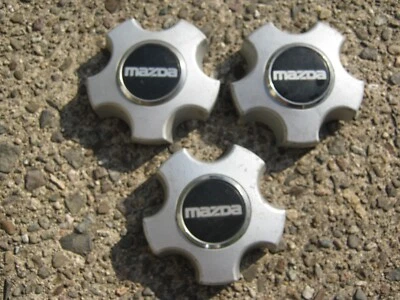 Genuine 1988 1989 Mazda MX6 626 alloy wheel center caps hubcaps - Image 1 of 4