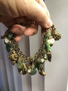 13. Rare MIRIAM HASKELL Brass Asian Motif Green Stone Charm Bracelet - Picture 1 of 12