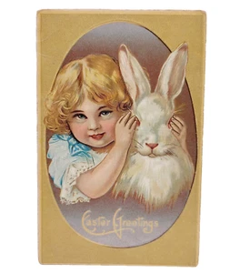 Antigua postal de saludos de Pascua niña eduardiana con conejo blanco usada - Imagen 1 de 3