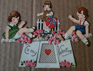 TARJETA DE SAN VALENTÍN DE COLECCIÓN NIÑO NIÑA EN TEETER TOTTER BALANCÍN MECÁNICO ALEMANIA  - Imagen 1 de 6