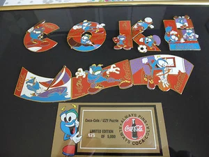 1 SELTENES COCA OLYMPIA MASKOTTCHEN COLA ATLANTA IZZY PUZZLE PIN SET IM RAHMEN - Bild 1 von 3
