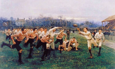 THE RUGBY MATCH SPORT GAME PLAYERS PAINTING BY WILLIAM BARNES WOLLEN REPRO - Image 1 of 3
