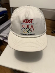OLYMPIA MÜTZE WEISS VINTAGE ONE SIZE DRUCKKNOPFLASCHE AT&T SPONSOR 80er 90er - Bild 1 von 6
