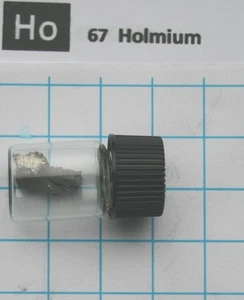 1 gram 99.9% Holmium metal pieces in glass vial element 67 sample - Foto 1 di 3