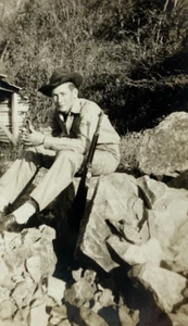Handsome Man With Rifle & Hat Sitting On Rocks B&W Photograph 2.75 x 4.25 - Picture 1 of 3