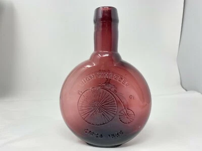 Botella de vidrio púrpura vintage Clevenger Brothers High Wheeler Boneshaker bicicleta Foto 1 de 4