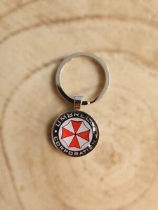 🍀 Resident Evil Schlüsselanhänger Keychain Umbrella Corp  - Bild 1 von 3