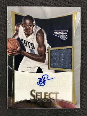 Parche Biyombo 2012-13 Panini Select #242 Bismack/299 Charlotte Bobcats Foto 1 de 2