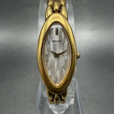 Seiko Watch Women 15mm Silver Dial Gold Tone Oval 2E20-7203 New Battery - Image 1 of 4