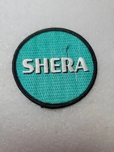 SHERA Embroidered Logo Patch Emblem Fabric Concrete Building Round Sew On Coat - Picture 1 of 8
