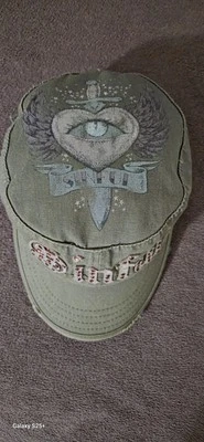 SINFUL...   khaki green cap with pink  rhinestones and evil eye  handpainted - Image 1 of 4