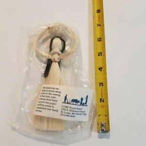 Basket weaving lady fiber Made by woman in New Delhi, India.  Lutheran Relief  - Picture 1 of 3