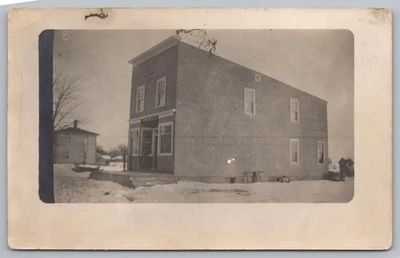 Brick Store Apartment Building on Snow Covered Street c1915 RPPC Photo Postcard - Image 1 of 2