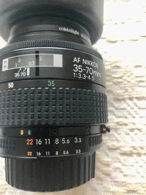 Nikon AF Nikkor 35-70mm  F 3:3-4.5 lens with skylight filter, 2 lens cover, hood - Image 1 of 3