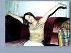 FOUND COLOR PHOTO S+3110 PRETTY WOMAN SITTING ON COUCH WITH ARMS OUT,EYES CLOSED