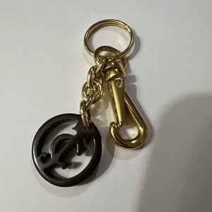 Juicy Couture Keychain Bag Charm Brown Round JC Logo Gold Tone Hardware Hangtag - Picture 1 of 13