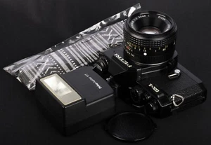 PETRI GX-1 reflex pellicola 35 mm completamente meccanica c/w obiettivo XR Rikenon L 50/2 e kit flash - Foto 1 di 11