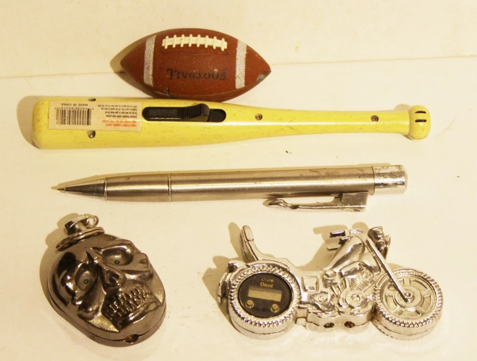 5 Novelty Lighters , Butane. football, baseball bat, skull, motorcycle, pen - Image 1 of 1