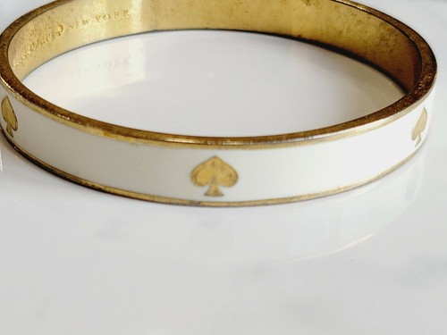 Bracciale Kate Spade bianco con vanga dorata