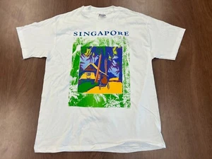 CAMISETA VINTAGE SINGAPUR 1991 DFS L PUNTADA ÚNICA DEADSTOCK NOS HANES TEE EE. UU. - Imagen 1 de 8