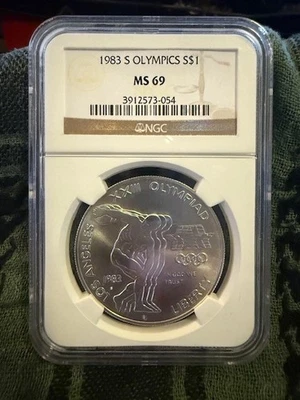 1983-S $1 Olympic Discus Commemorative Silver Dollar - NGC MS 69 - Image 1 of 2