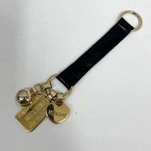 Vintage Moschino Leder Schlüsselanhänger lang schwarz mit 3 goldenen Metall Charms - Bild 1 von 5