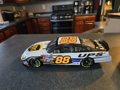 1/24 Action Dale Jarrett #88 UPS Talladega Raced Win Version 2005 Taurus W/ Tire - Image 1 of 4
