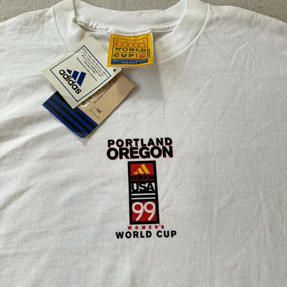 CAMISETA VINTAGE DE LA COPA MUNDIAL FEMENINA Portland 1999 FIFA NUEVA CON ETIQUETAS NUEVA Rara USA Chastain Foto 1 de 4