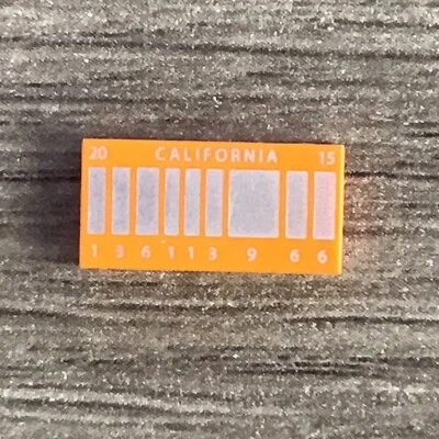 LEGO DELOREAN ORANGE LICENSE PLATE 1x2 TILE from 21103 set Part# 3069bpb0287 - Image 1 of 2