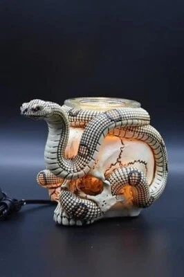 Calentador de aceite aromático eléctrico calavera y serpiente tarta eléctrica de poliresina y aceite y calentador Foto 1 de 2