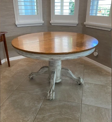 Dining table in Vintage Tiger Oak.  48" wide with three 12" leaves.  Veneer top. - Image 1 of 4
