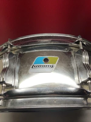 Distintivo rullante risonante vintage Ludwig X sottile trasparente 5x14 8 alette blu/oliva 1978-82 - Immagine 1 di 4