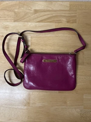 Michael Kors logo-embossed crossbody bag in a vibrant fuchsia or magenta color - Image 1 of 4