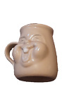 Vintage and whimsical 3D effect friendly and laughing face mug with toothy grin