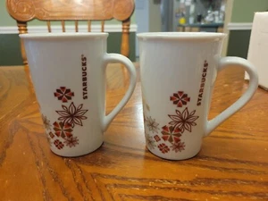 Two Starbucks Christmas Holiday 2013 Coffee Mug Poinsettia Snowflake Star 12 oz - Picture 1 of 3