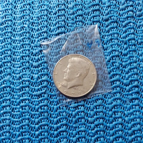 #95 . 1977 p kennedy  half dollar  Uncirculated i opened package.  pictured Cover