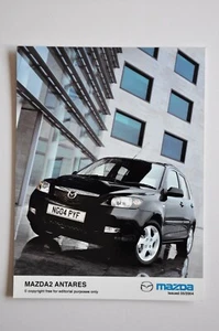 Foto de prensa de coche - Mazda 2 Antares 2004 - negro - vista frontal/lateral - Imagen 1 de 1
