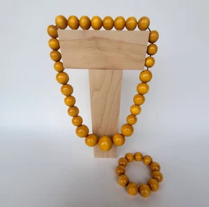 STRING OF WOODEN BEADS IN DIFFERENT SIZE WITH BRACELET IN ORANGE COLOUR - Picture 1 of 2