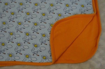 Manta Bebé Dulce Cacahuete Pato Ganso Naranja Azul Sol Nubes Algodón Orgánico Lovey Foto 1 de 4