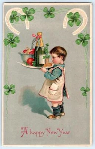 1910 HAPPY NEW YEAR CHILD TRAY CHAMPAGNE BOTTLE HORSESHOES SHAMROCKS POSTCARD - Picture 1 of 2