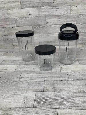 Magic Bullet Cups 1 With Handles, 1 Tall, & 1 Short. 2 Lids, 1 To Go Lid. - Image 1 of 4
