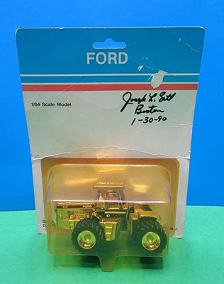1/64 Gold ERTL Ford 876 4WD Tractor - Poor Package Flat. - Image 1 of 4