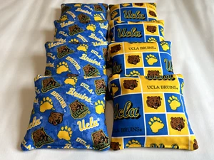 BOLSAS DE FRIJOLES UCLA BRUINS CORNHOLE ~ JUEGO DE 8 BOLSAS LLENAS DE RESINA PARA TODO TIPO DE CLIMA JUEGO DE LANZAMIENTO - Imagen 1 de 1