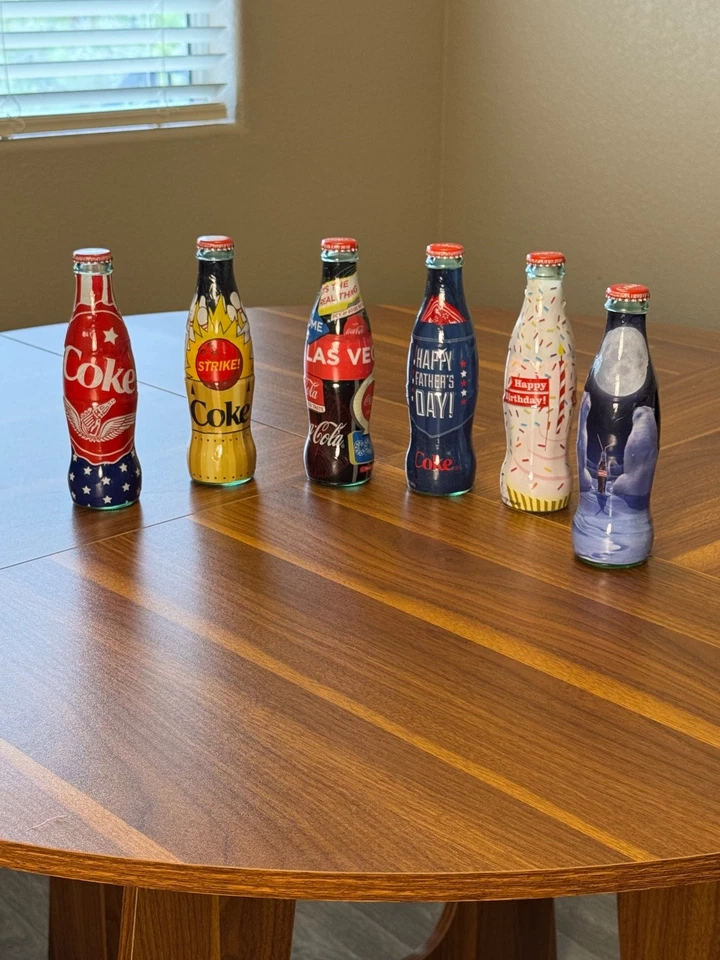 Лот из 6 алюминиевых бутылок Coca-Cola — запечатанные ограниченные выпуски — коллекционная упаковка - Изображение 1 из 4