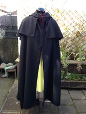 black venetian style cloak with purple lining