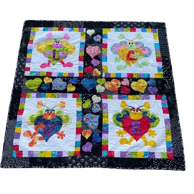 Quilt Four Blocks with Whimsical But Like Creatures Each Holding A Heart - Image 1 of 2