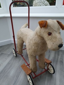 toy dog on wheels with lead