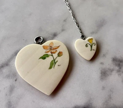 NWT:  Set of 2 Creme Heart Shaped Ceramic Pendants, Floral Designs W Necklace - Image 1 of 4