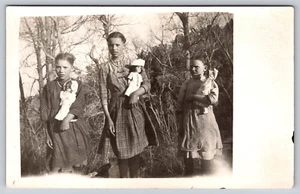 Postcard RPPC Two Group 3 Girls Holding Dolls Entire Family On Rocks - Picture 1 of 4