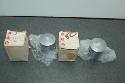 2 PISTONES NUEVOS ORIGINALES SUZUKI 12110-25603-100 +1,00 GRAN TAMAÑO 1973-1978 GT185 PAR Foto 1 de 4